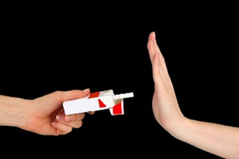 Hand refusing a pack of cigarettes, symbolising rejection of smoking and commitment to addiction prevention