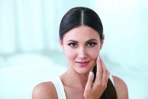 Attractive middle-aged woman with radiant skin, representing the results of non-invasive anti-ageing treatments.
