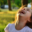 Child laughing joyfully outdoors — illustrating the simple, natural benefits of laughter for health and happiness.