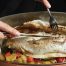 Baked sea bass recipe with vegetables — kidney-friendly seafood dish being served.