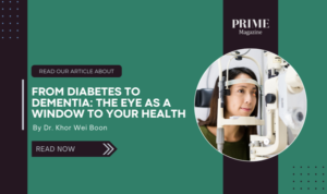 A woman undergoing an eye examination with specialized equipment, promoting the Prime Magazine article “From Diabetes to Dementia: The Eye as a Window to Your Health” by Dr. Khor Wei Boon.