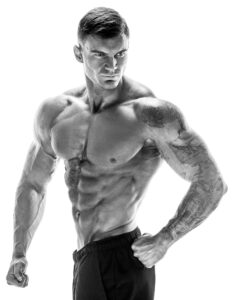 A muscular bodybuilder flexing in a gym, showcasing strength and muscle growth.
