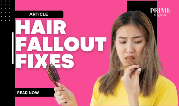 Close-up of a woman holding a hairbrush with strands of hair, with the words 'Hair Fallout Fixes' overlaid.