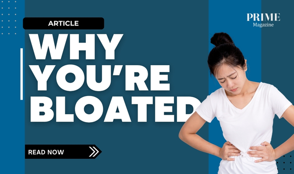 Woman holding her stomach, showing discomfort from bloating.