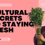 A smiling woman in traditional attire holds a bundle of fresh green herbs against a pink background with bold text that reads “Cultural Secrets to Staying Fresh.”