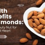 A white heart-shaped bowl filled with almonds on a rustic wooden table, representing the health and beauty benefits of almonds for skin and heart.