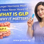 Young woman holding a blue GLP-1 pen beside a 3D digestive system graphic with the words “What is GLP and Why It Matters” on a Prime.sg health banner.