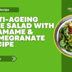 Bowl of anti-ageing rice salad with edamame, spinach, and pomegranate on a green recipe banner.