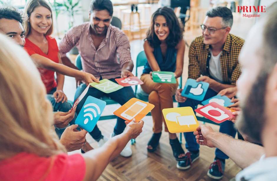 Group of friends holding social media icons and interacting, representing social connection without alcohol.
