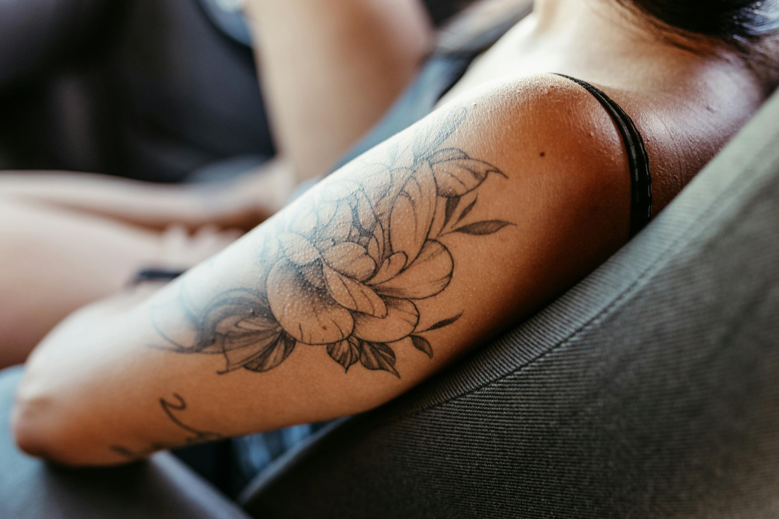 Elegant floral upper-arm tattoo highlighting popular nature-inspired designs chosen for their timeless appeal.
